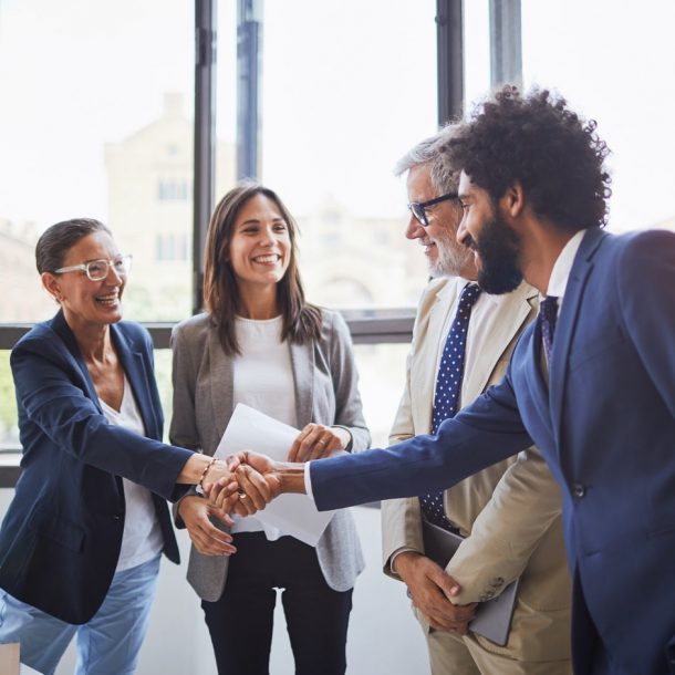 Diverse group of professionals shaking hands