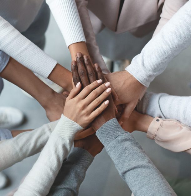 Picture of people putting their hands together