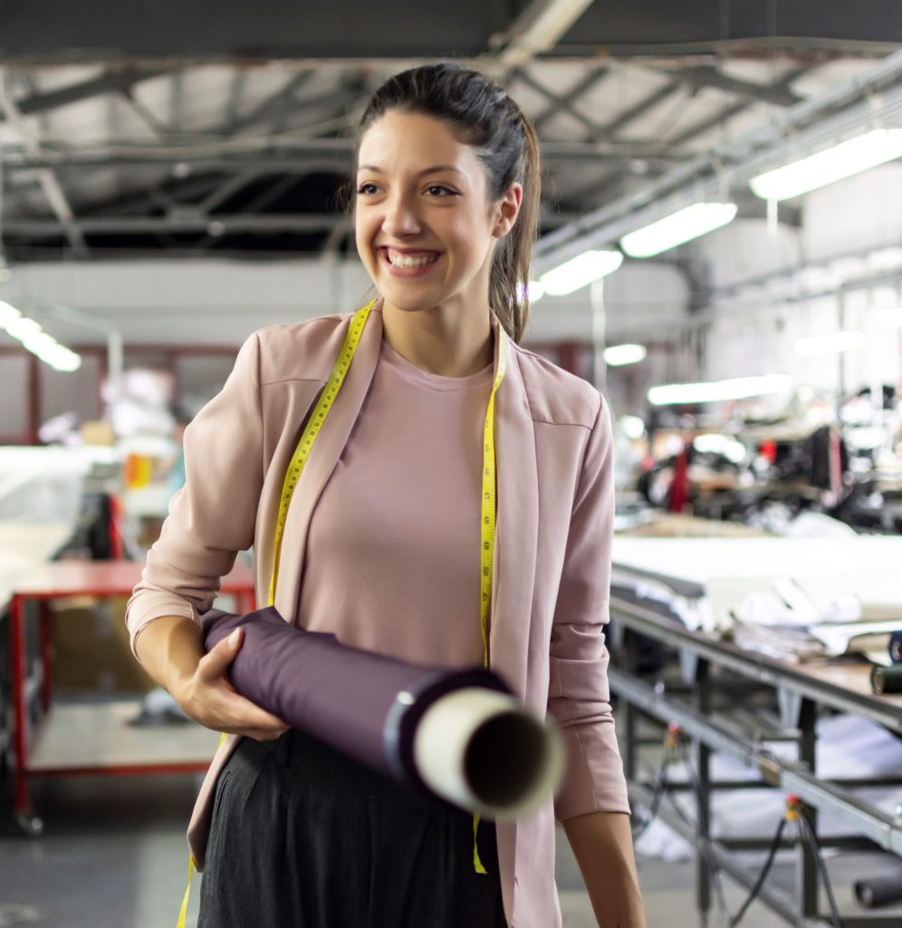 Latina carrying a bolt of fabric