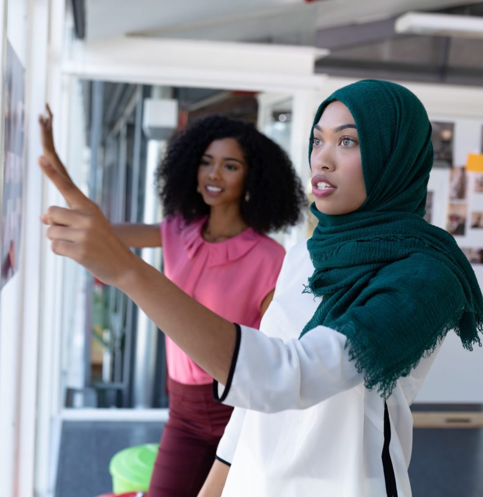 Muslim woman and Black woman working on a project